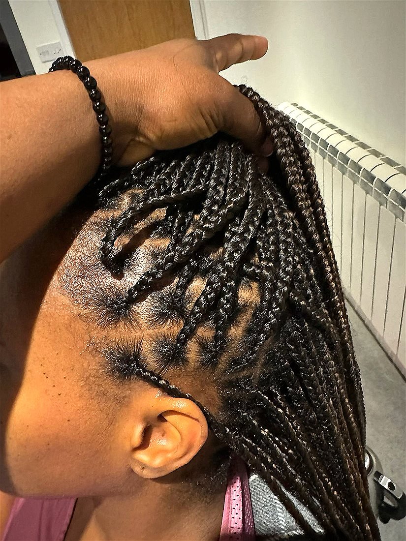 Braiding in progress at Sandriq Braids Hair Studio