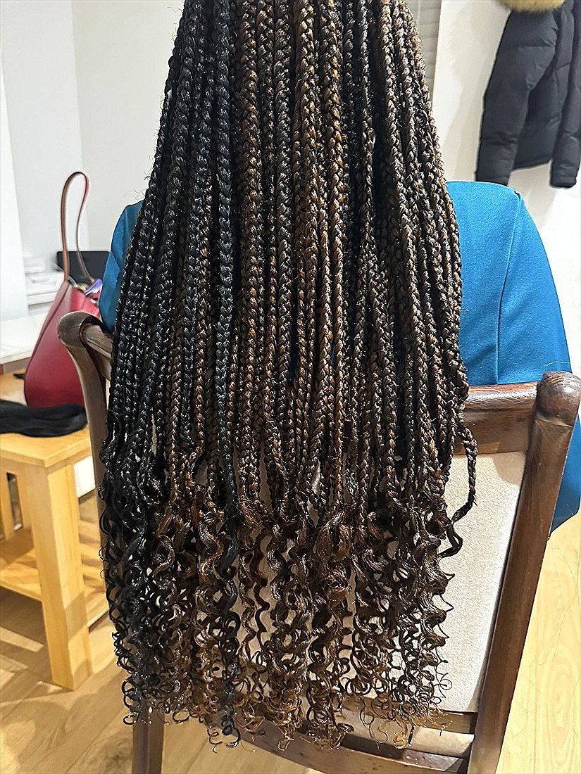 Curly braided ends styled at Sandriq Braids Hair Studio